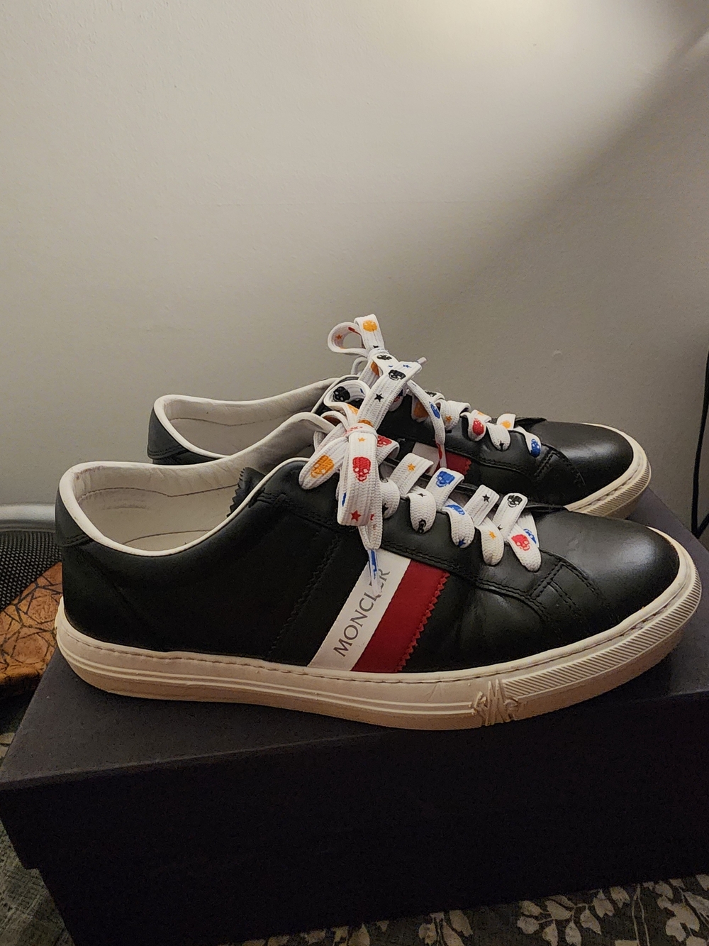 Authentic Moncler Black Leather Sneakers with Red and White Stripe.